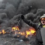 A pro-European protester swings a metal chain during riots in Kiev