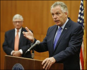Governor McAuliffe explains his plan to close budget shortfall this year. Secretary of Finance "Ric" Brown stands in the background.