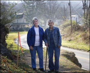 Fern and Earl Echols stand near a pipeline marker on their property in Giles County. Photo credit: Roanoke Times