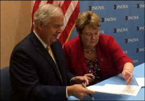 Inova CEO Knox Singleton and UVa President Teresa Sullivan sign partnership deal. Photo credit: Washington Business Journal