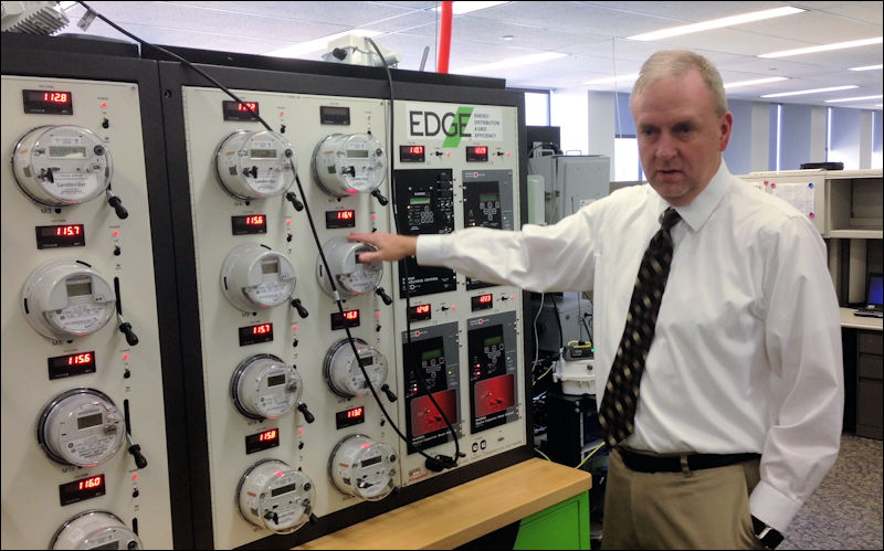 Todd Headlee, director of Dominion Voltage Inc., shows off the in-house electric circuit the company uses to model upgrades to its conservation voltage reduction system.