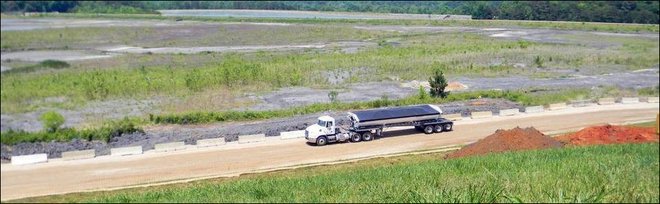 A truck embarks upon coal ash clean-up at a Duke Energy. 