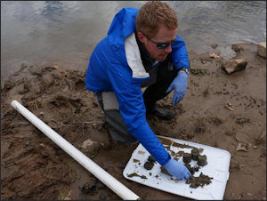 A North Carolina riverkeeper inspects testing samples of coal ash taken from the Dan River. 