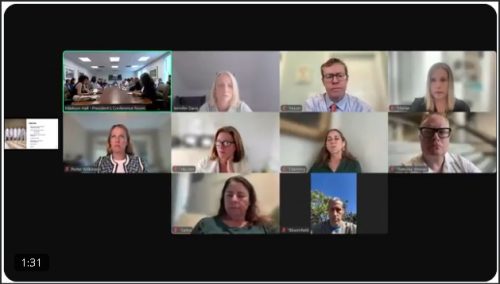 A grid view of a virtual meeting showing multiple participants on video call, with a mix of professional backgrounds.