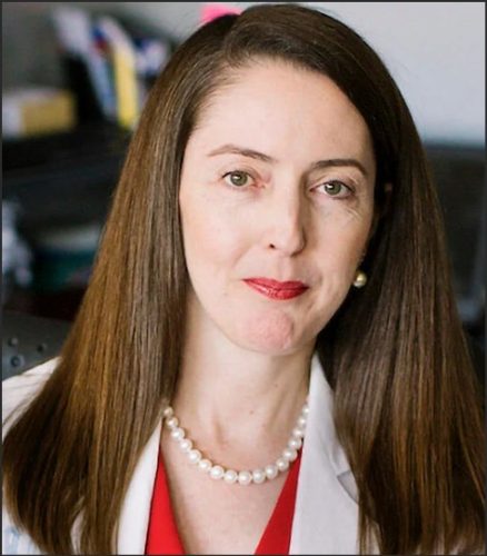 Professional headshot of Melina Kibbe, dean of the University of Virginia Medical School, wearing a white coat and a pearl necklace.