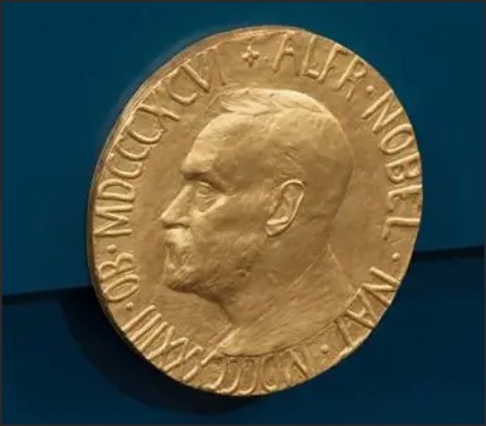 Close-up view of a gold Nobel Prize medal featuring the profile of Alfred Nobel.